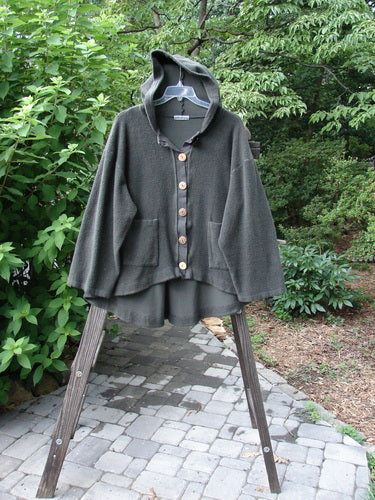 Barclay Celtic Moss Swing Hooded Jacket in Unpainted Army Grey Size 2, featuring a cozy hoodie, oversized buttons, A-line shape, and drop pockets, displayed on a rack showcasing its plush texture.
