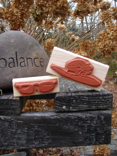 1997 New Rubber Stamps Beach Theme One Size: A pair of wooden blocks featuring beachy sunglasses and a fancy sun hat, perfect for customizing stationery or decorating wrapping paper. Unused and in mint condition.