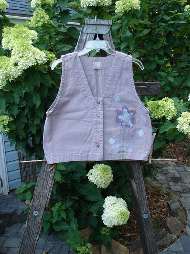 2000 Parachute Cross Stitch Vest Floral Pale Purple Altered Size 0, featuring a deep V neckline, floral patterns, four metal buttons, and a straight-edged bottom, displayed on a mannequin.