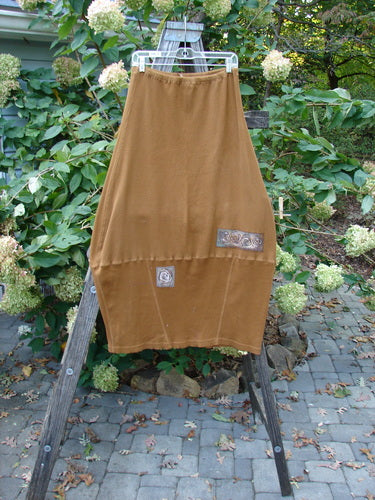 Barclay Patched Thermal Parlor Skirt Floral Copper Size 0 displayed on a wooden ladder, showcasing its unique vertical and horizontal stitchery with a widening lower reverse bell shape.