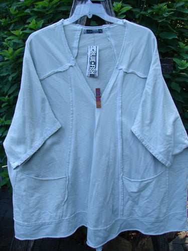 Barclay NWT Photogram Open Front Jacket Unpainted Dew OSFA featuring wide three-quarter sleeves, an angular hem, and dolman shoulders, displayed on a hanger, highlighting its generous, boxy silhouette and raw edges.