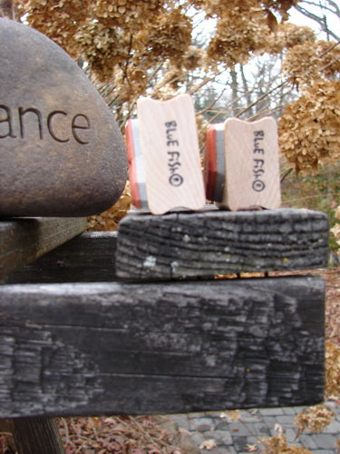 Close-up of two unused rubber stamps on wooden blocks, featuring blue fish designs, titled 1997 New Rubber Stamps Uptown Gal Theme One Size.