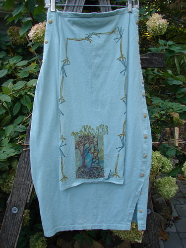 1994 Apron Skirt Magic Garden Menthe Size 1, featuring a sweet painted front apron panel, layered presentation, and numerous vertically curved side buttons, embodying a vintage Blue Fish Clothing aesthetic.