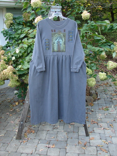 1997 PMU Patched Long Sleeved Simple Cuff Dress Window Granite Size 2 displayed on a swing, showcasing its full-length A-line design, cozy long sleeves, and abstract patchwork detailing.