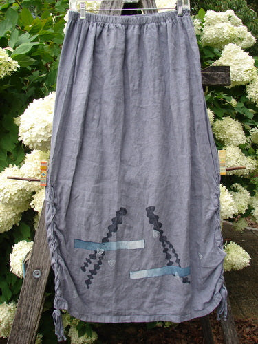 Bluefishfinder.com 1997 Breeze Skirt Sealife Naya Size 1 in gray, a long crinkled skirt with a gathered elastic waistband, side ties, and a soft draped silhouette. Dark sea-life motifs and pale blue accents sit near the hem against the textured fabric.