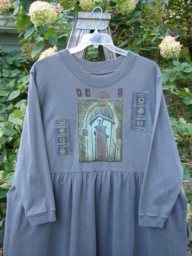 The 1997 PMU Patched Long Sleeved Simple Cuff Dress Window Granite Size 2 hangs on a swinger, showcasing its A-line sweep, ribbed neckline, and abstract patch detailing.