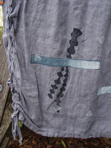 Bluefishfinder.com 1997 Breeze Skirt Sealife Naya Size 1 in gray, a soft, crinkled fabric panel with a ruched side tie and abstract sealife-style prints in dark navy and pale blue. The composition is close and vertical, with weathered texture and muted tones.