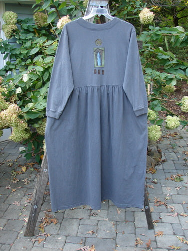 1997 PMU Patched Long Sleeved Simple Cuff Dress Window Granite Size 2 on a rack, showcasing its full length, A-line sweep, ribbed neckline, and cozy long sleeves with abstract patch details.