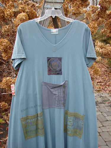 2000 PMU City Side Dress with patchwork design, V neckline, and painted pockets. Made from organic cotton. Size 1.