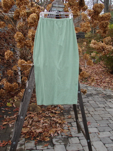 1995 Column Skirt on wooden ladder, Spanish Moss, Tiny Size 2, unpainted, elastic waist, tapered shape, pegged hemline, back kick vent.