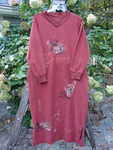 1996 Pastime Dress Abstraction Ember Size 2: A long red dress featuring cartoon faces, vented sides, and cozy ribbed cuffs, showcasing unique contrast stitchery and deep side pockets, embodying vintage Blue Fish creativity.