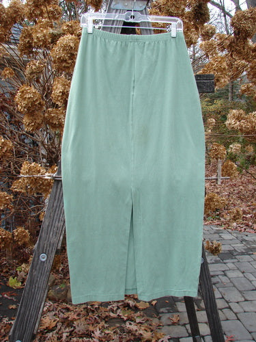 1995 Column Skirt, Spanish Moss, Tiny Size 2: Tapered pants on wooden ladder, close-up of woman's skirt, and close-up of pants.