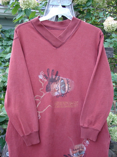 1996 Pastime Dress Abstraction Ember Size 2 features a red sweater with a cartoon motif, cozy cuffed long sleeves, ribbed neckline, and deep inseam pockets, embodying vintage Blue Fish Clothing's creative style.