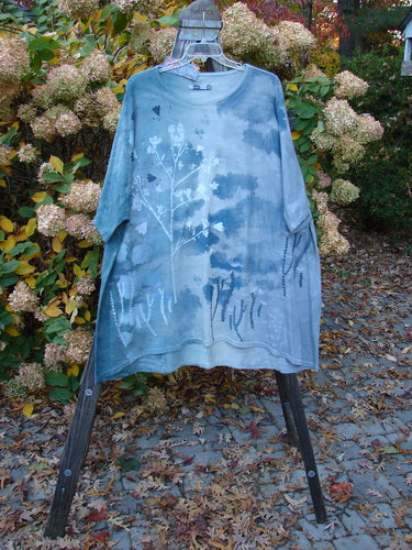 Barclay NWT Art Top Botanical Tree Emerald Fog OSFA displayed on a rack, showcasing its tunic length, three-quarter sleeves, rounded neckline, and botanical tree design with a clouded background.