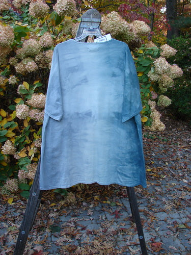 Barclay NWT Art Top Botanical Tree Emerald Fog OSFA displayed on a mannequin, showcasing its tunic length, drop shoulders, loose three-quarter sleeves, rounded neckline, and varying hemline.