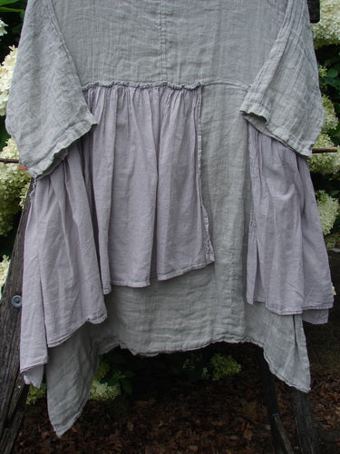 Barclay Gauze Batiste Petal Urchin Flounce Dress in Unpainted Rice Paper, size 1, with layered gauze batiste panels in soft gray and lavender tones. The loose, ruffled silhouette hangs in uneven tiers, showing a crinkled, airy texture and draped sleeves.