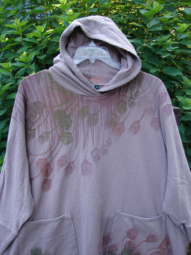 Barclay Cotton Hemp Hooded Folklore Pullover Tiny Floral Mallow OSFA, showcasing a cordless hood, slightly fitted ribbed cuffs, long sleeves, dual exterior pockets with floral designs, and a wide flared swing.