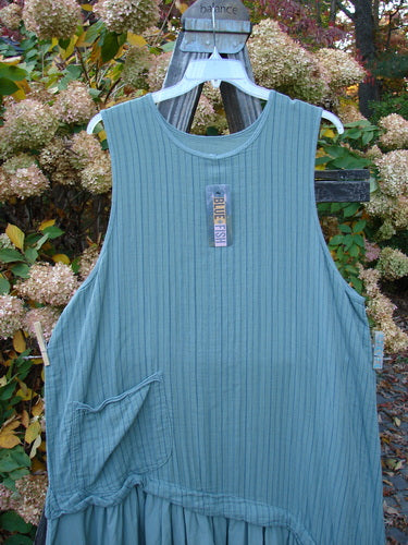 Barclay NWT Gauze Varano Jumper Olive Navy Pinstripe Size 2 displayed on a swing, showcasing its lightweight organic cotton gauze fabric, diagonal bodice, and ruffled hem.