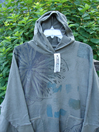 Barclay NWT Cotton Hemp Hooded Folklore Pullover Blossom Grey Lolite OSFA displayed on a hanger, showcasing its cordless hood, ribbed cuffs, flared swing, and dual painted pockets in cozy organic cotton hemp blend.