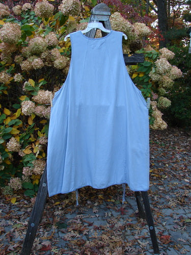 Barclay NWT Twill Joyous Jumper Unpainted Sky Size 2 displayed on a clothes rack, highlighting its A-line shape, double pockets, and deep arm openings.