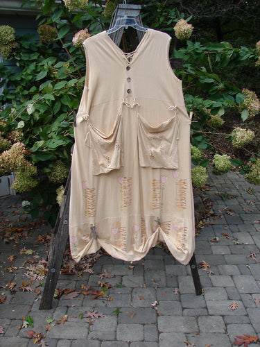 Barclay Salt Water Taffy Jumper Tulip Garden Wheat Size 2 on a rack, showcasing its unique tie-on tie-off front pockets and shell-textured buttons, reflecting BlueFishFinder's vintage style.