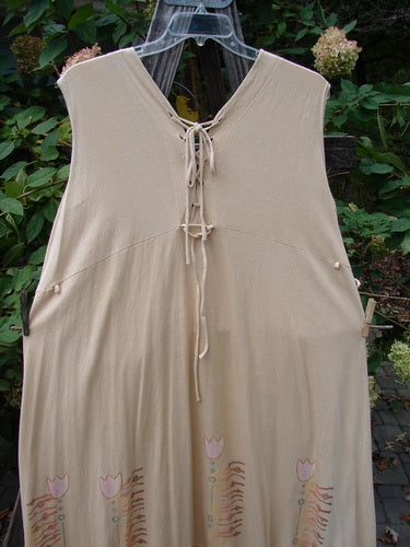 Barclay Salt Water Taffy Jumper Tulip Garden Wheat Size 2 displayed on a wooden pole, featuring rippie accents, tie-off pockets, shell-textured buttons, and a tulip garden theme, embodying vintage Blue Fish style.