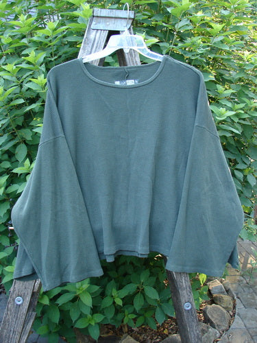 Barclay Patched Thermal Donna Top Out West Deep Army OSFA displayed on a hanger, showcasing its wide neckline, belled sleeves, and A-line flair with a textured waffle pattern.