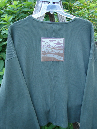 Barclay Patched Thermal Donna Top Out West Deep Army OSFA features a white and purple mountain graphic, belled sleeves, and a patch on a soft thermal fabric, embodying Bluefishfinder's vintage style.