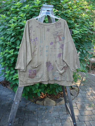 Barclay Cotton Hemp Rolled Writer's Pullover BF Kitty XOXO Mandorla OSFA features a wide square flair, raw flutter neckline, dual pockets, and continuous kitty theme art, displayed on an outdoor hanger.