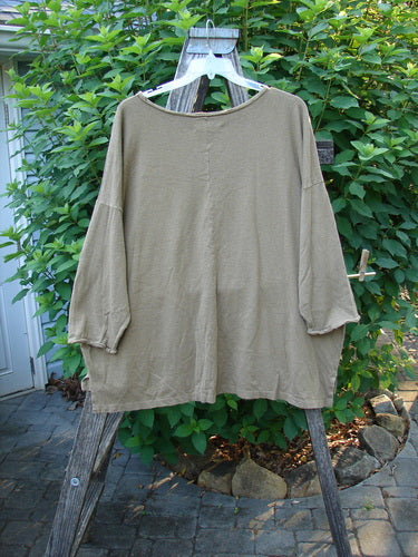 Barclay Cotton Hemp Rolled Writer's Pullover BF Kitty XOXO Mandorla OSFA displayed on a hanger, showcasing its unique rounded raw neckline, dual pockets, and distinctive kitty-themed design, embodying BlueFishFinder's vintage style.