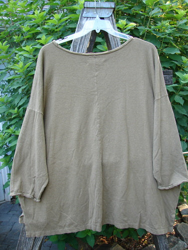 Barclay Cotton Hemp Rolled Writer's Pullover BF Kitty XOXO Mandorla OSFA displayed on a hanger, showcasing its rounded raw neckline, wide square flair, dual drop flop pockets, and vertical rear seam.