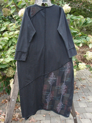 Barclay Diagonal Pocket Dress Stick Stone Black Size 0 features a long A-line silhouette, slight V-neck, multi-diagonal seams, and a top-entry pocket, displayed on a wooden rack.