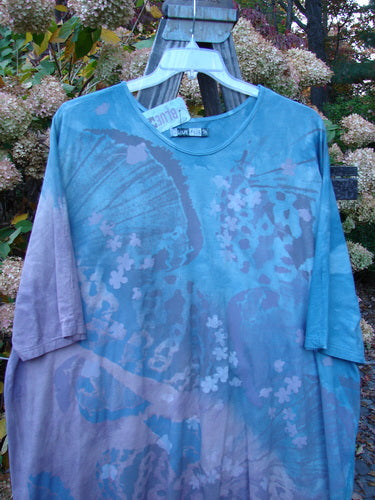Barclay NWT Tournesol Top Abstract Floral Denim Amethyst OSFA featuring butterfly and floral designs, longer tunic length, drop shoulders, loose three-quarter sleeves, rounded neckline, varying hemline, and abstract floral theme.