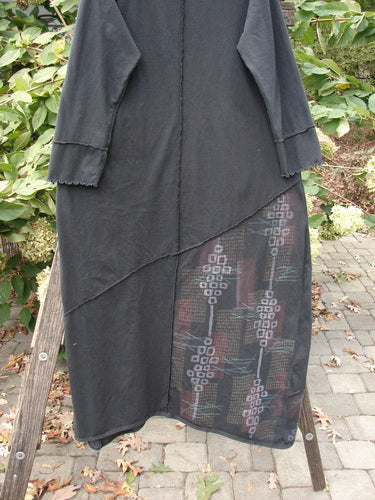 Barclay Diagonal Pocket Dress Stick Stone Black Size 0 features a unique diagonal seam design, extra-long length, slight V-neckline, and front pocket, showcasing intricate pattern details and rolled hem.