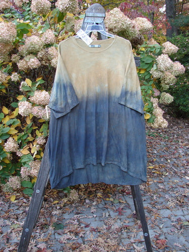 Barclay NWT Art Top Sunfield Bronze Gold OSFA displayed on a hanger, featuring a longer tunic length, drop shoulders, three-quarter sleeves, rounded neckline, and an upward rounded front hem.