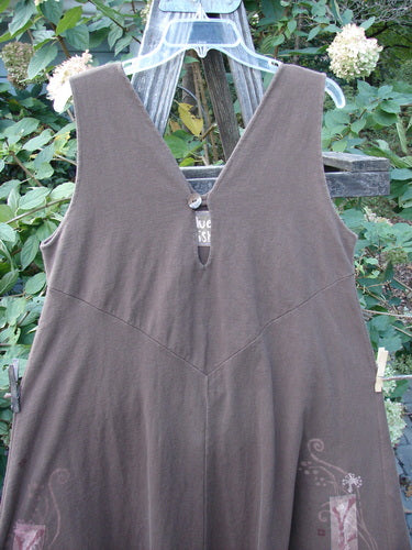 1997 Charmer's Jumper Magic Forest Mandorla Size 1 displayed on a clothes rack, featuring a sleeveless design, wide A-line flair, keyhole front with shell button, and vertical center seams.