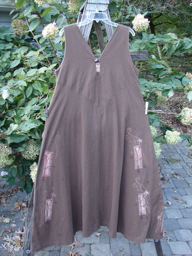 1997 Charmer's Jumper Magic Forest Mandorla Size 1, a sleeveless, wide A-line dress with a keyhole front and shell button, displayed on a clothesline, showcasing its unique design features.