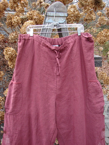 Barclay Linen Heavy Tie Travel Pant in Tiny Birdie Merlo, Size 2, displayed outdoors, featuring an elongating billowy shape with triangular side inserts and two wrap pockets.