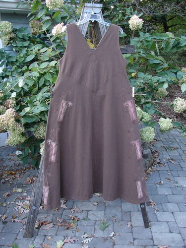 1997 Charmer's Jumper Magic Forest Mandorla Size 1 displayed on a rack, showcasing its sleeveless design, wide A-line flair, and keyhole front with a shell button from Bluefishfinder.com.