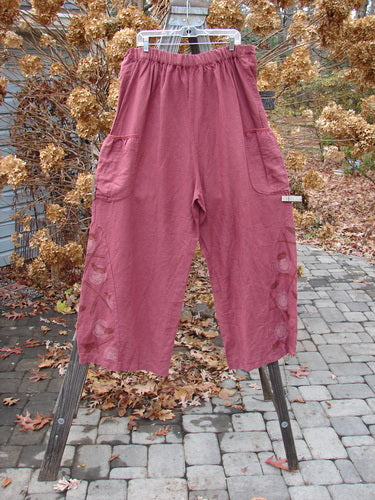 Barclay Linen Heavy Tie Travel Pant Tiny Birdie Merlo Size 2, displayed on a rack, featuring an elongating billowy shape, triangular side inserts, and a drawcord waistline with an elastic back.