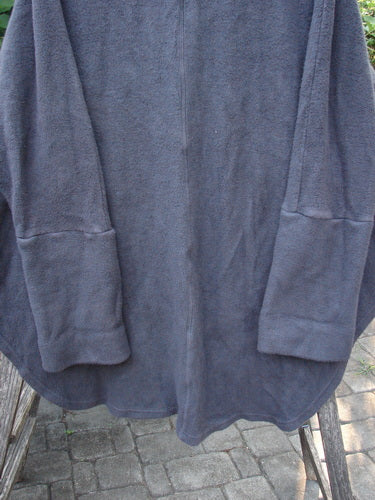 Close-up of Barclay Patched Celtic Moss Deco Coat Unpainted Stormy Black OSFA, showcasing thick cotton fleece, oversized vintage buttons, and deep Dolman sleeves, embodying BlueFishFinder's vintage clothing ethos.