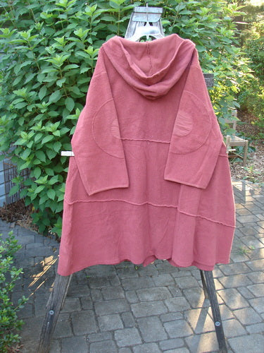 Barclay Celtic Moss Hooded Curve Coat Unpainted Sunset Size 2 features a super cozy hood, giant circle sleeve patches, and an S-shaped button line, showcasing unique exterior stitchery and deep pockets.