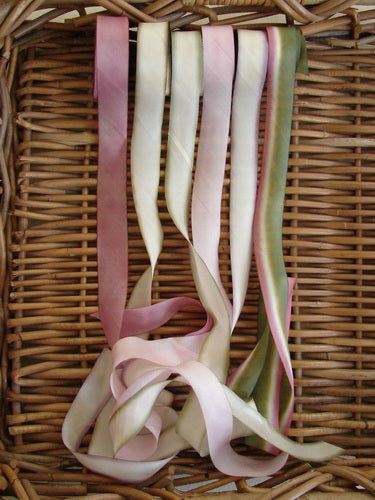 Blue Fish Hand Dyed Silk Ribbon in Sweet Meadow 108 x 1 displayed in a woven basket, showcasing its light, flowing texture and unique color variance, ideal for vintage Blue Fish clothing adornments.