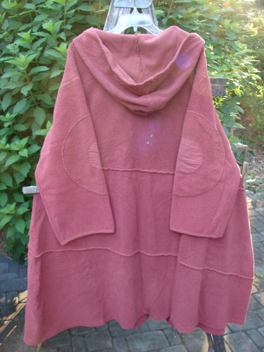 Barclay Celtic Moss Hooded Curve Coat Unpainted Sunset Size 2 featuring a cozy hood, giant circle sleeve patches, S-shaped button line, and deep pockets, showcasing a sweeping A-line flair with exterior stitchery.