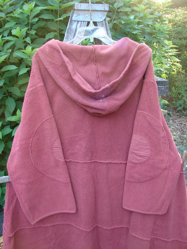 The Barclay Celtic Moss Hooded Curve Coat Unpainted Sunset Size 2 features a cozy hood, circle sleeve patches, and an S-shaped button line, reflecting Bluefishfinder.com's vintage creativity.