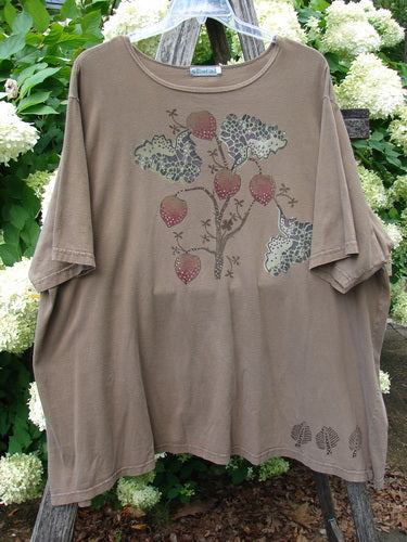 Barclay Short Sleeved Studio Tee Tree Offer Fauna Size 3 in muted taupe, a loose short-sleeved T-shirt with a soft drape and faded finish. The front shows a delicate tree-and-acorn style graphic in mottled green and red tones, hanging against leafy greenery.