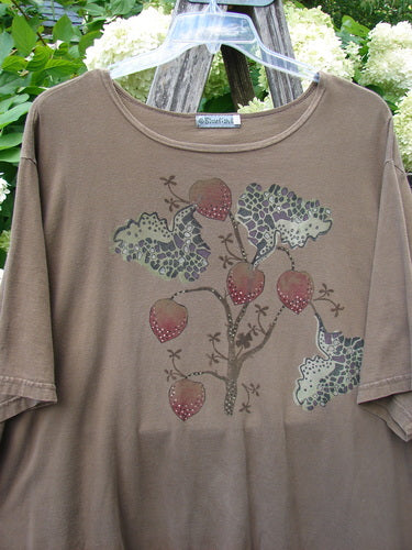 Barclay Short Sleeved Studio Tee Tree Offer Fauna Size 3 in muted brown, a short-sleeved T-shirt with a round neckline and a centered tree-and-fauna graphic in earthy tones and red accents. The soft knit fabric hangs on a clear hanger, with leafy greenery and pale flowers behind it.