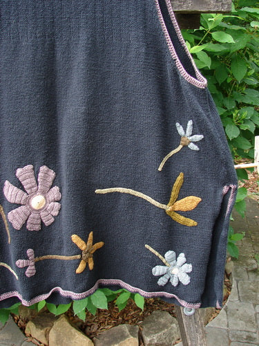 1998 Limited Edition Peruvian Embroidered Sweater Vent Tunic Floral Vine Black OSFA, showcasing intricate floral vine embroidery and contrasting whip stitching, with yarn-covered buttons and side vents on a textured knit backdrop.