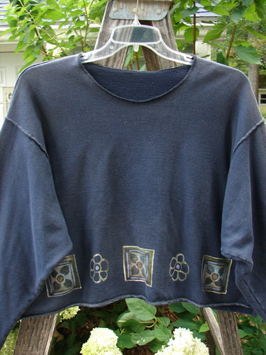 1997 Fleece Long Sleeved Boxy Top Mosaic Flower Ebony Size 2, featuring a wide, slightly A-lined shape, exterior whip stitching, drop shoulders, and a mosaic flower design around the hem.