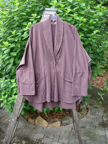 Barclay Reprocessed Golden Hour Deco Jacket Rear Parrot Plum Wine OSFA on a wooden stand, showcasing its flowing varying lengths, deep V-shaped neckline, and oversized diagonal pockets, emphasizing vintage style.